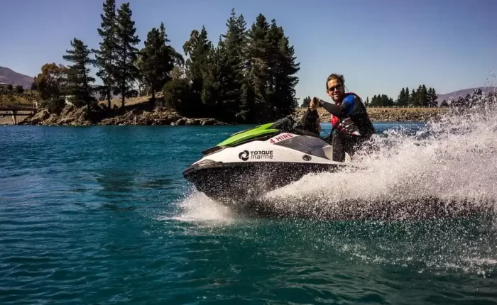 A jet skier enjoying the spray of water and the stunning backdrop of Lalla Takerkoust Lake, near Marrakech, Morocco
