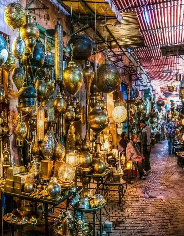 Craftsmen at work in the bustling Metal Souk Addadine, amidst a variety of traditional metal creations, in the heart of Medina Marrakech