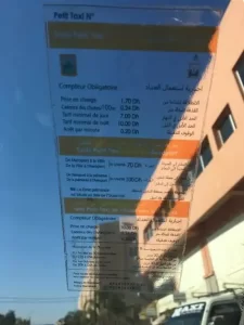 A brightly colored taxi waiting in the vibrant streets of Marrakech, representing the efficient and conveniently priced transport service available in the city