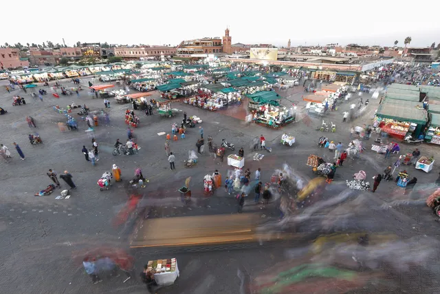 A vibrant market scene in Marrakech showcasing colorful textiles, spices, and local artisans, highlighting fun activities to explore.
