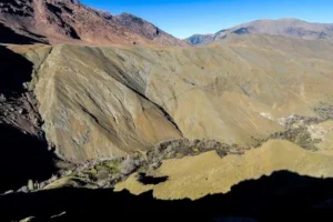 Hikers trekking through the scenic trails of the Atlas Mountains, surrounded by breathtaking landscapes and vibrant flora.